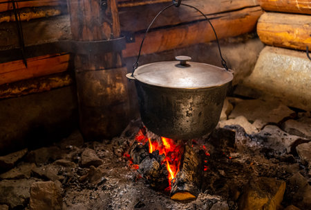A large vat in which cheese is cooked over an open fire.の写真素材