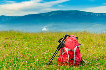 Trekking with a backpack and trekking poles along the ridge in the mountains.の写真素材
