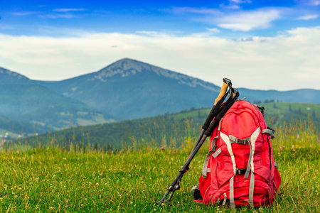 Trekking with a backpack and trekking poles along the ridge in the mountains.の写真素材
