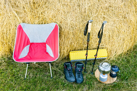 Hiking with a backpack and trekking poles in the mountains. Camping and trekking equipmentの写真素材