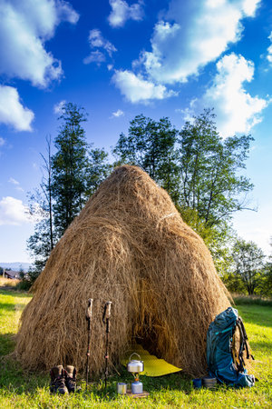 Hiking with a backpack and trekking poles in the mountains. Camping and trekking equipmentの写真素材