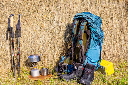 Hiking with a backpack and trekking poles in the mountains. Camping and trekking equipmentの写真素材