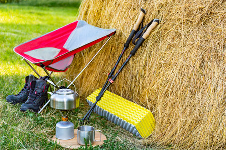 Hiking with a backpack and trekking poles in the mountains. Camping and trekking equipmentの写真素材