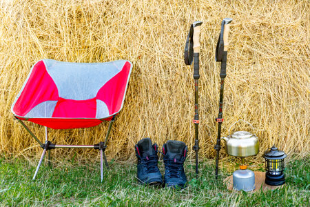 Hiking with a backpack and trekking poles in the mountains. Camping and trekking equipmentの写真素材