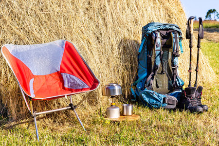 Hiking with a backpack and trekking poles in the mountains. Camping and trekking equipmentの写真素材