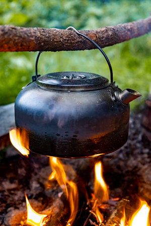 Coffee pot on a campfire during a hike in the mountains.の写真素材