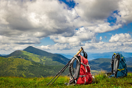 Hiking in the mountains with two backpacks in the summer.の写真素材