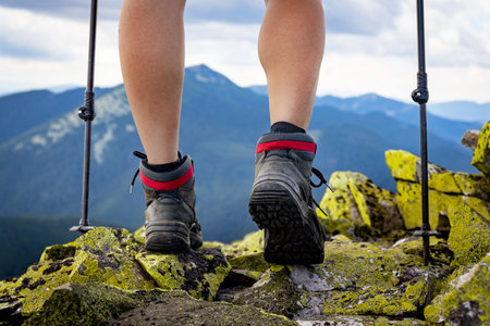 Hiking in the mountains with walking poles, beautiful views.の写真素材