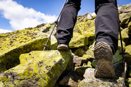Hiking in the mountains with walking poles, beautiful views.の写真素材
