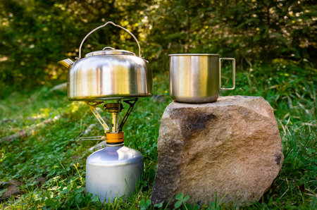Making tea in a kettle while hiking in the mountains.の写真素材