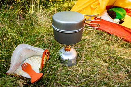 Camping with a tent and cooking equipment in the mountains.の写真素材