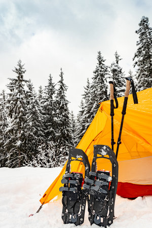 Hiking in the mountains with snowshoes and a backpack and a tent, hiking equipment.の写真素材