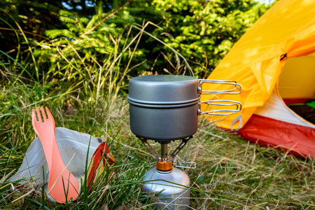 Camping with a tent and cooking equipment in the mountains.の写真素材