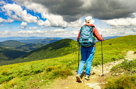 Hiking in the mountains with a backpack in summer.の写真素材