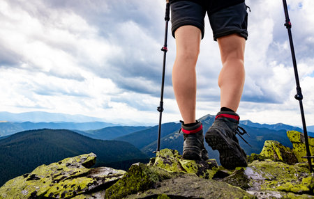Hiking in the mountains with walking poles, beautiful views.の写真素材