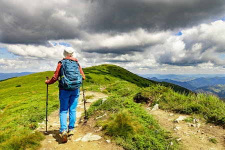 Hiking in the mountains with a backpack in summer.の写真素材