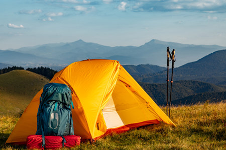 Hiking in the mountains in summer with a backpack and a tent. Beautiful landscape in the mountains.の写真素材