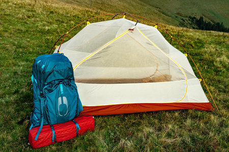 Hiking in the mountains in summer with a backpack and a tent. Beautiful landscape in the mountains.の写真素材