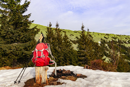 Hiking in the mountains in spring with a backpack and trekking poles along a mountain ridge.の写真素材