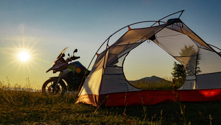 Moto trip on a motorcycle, camping in a tent in the mountains.の写真素材