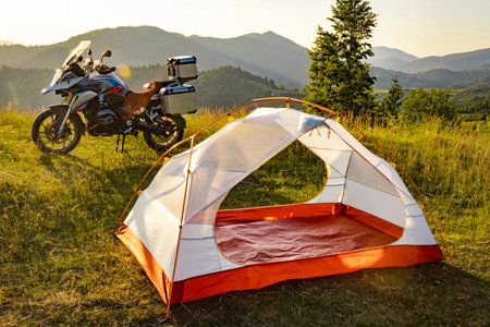 Moto trip on a motorcycle, camping in a tent in the mountains.の写真素材