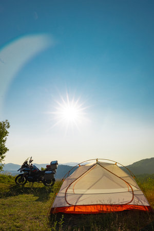 Moto trip on a motorcycle, camping in a tent in the mountains.の写真素材