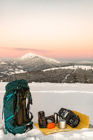 Hiking in the mountains with snowshoes, a backpack and a tent, hiking equipment.の写真素材
