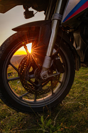 Motorcycle against the backdrop of a mountain landscape, beautiful sunset.の写真素材