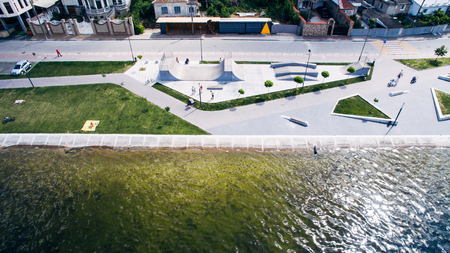 Aerial view from above on the skate park near the lake. Health zone.の写真素材
