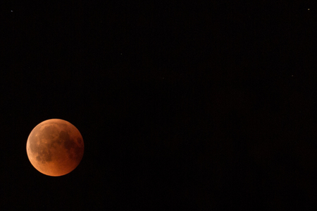 Lunar eclipse in the black night skyの写真素材