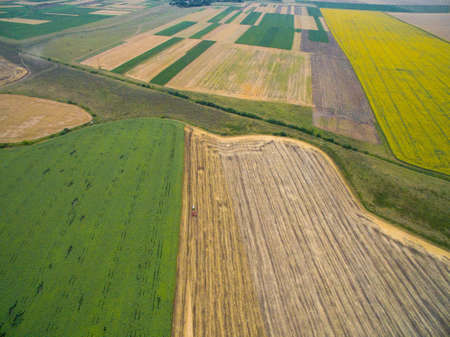 Harvesting in the field. Aerial view. A Lot of Land