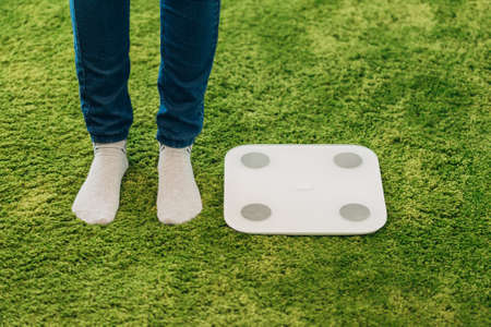 Girl Measures Weight During Diet. Smart Scales for Home.の写真素材