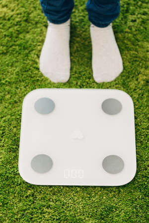 Girl Measures Weight During Diet. Smart Scales for Home.