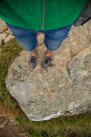 People descend down a large green mountain range. Mountain Hiking
