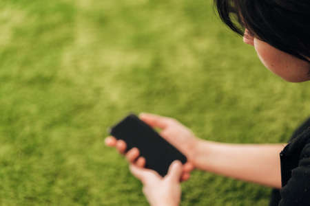 Girl Holds An New Smart Phone In Her Handの写真素材