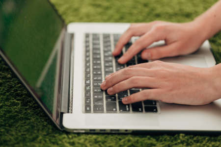 Close-Up Shot of Human Hands Placed Over Laptop