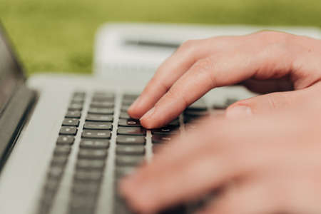 Close-Up Shot of Human Hands Placed Over Laptop