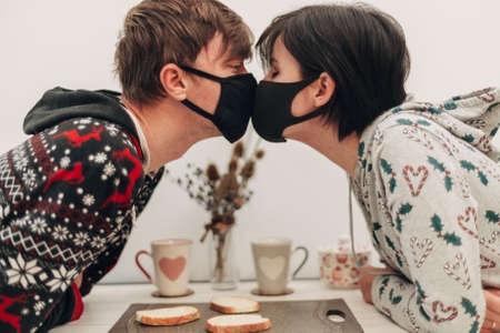 Girl and Boy Kissing in Masks on Coronavirus Quarantine