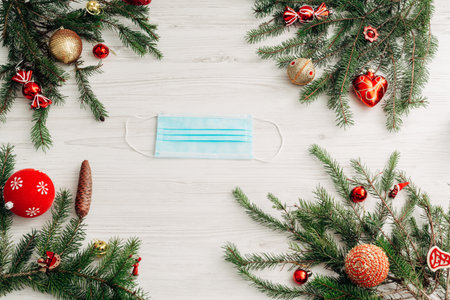 Christmas Composition with Mask on a White Wooden Table with Copy Spaceの写真素材