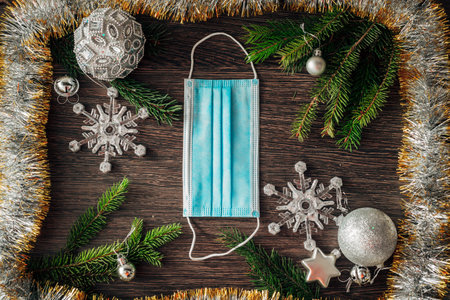 Christmas Tree Branches and Snowflakes on a Brown Background with Copy Space