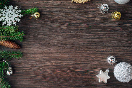 Christmas Tree Branches and Snowflakes on a Brown Background with CopySpaceの写真素材
