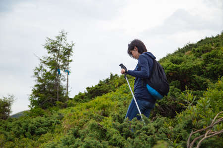 Girl Descend Down a Large Green Mountain Rangeの写真素材