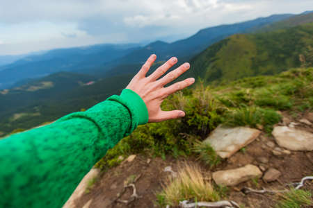 Man Descend Down a Large Green Mountain Range