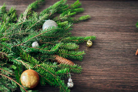 Christmas Tree Branches on a Brown Background with CopySpace for Textの写真素材