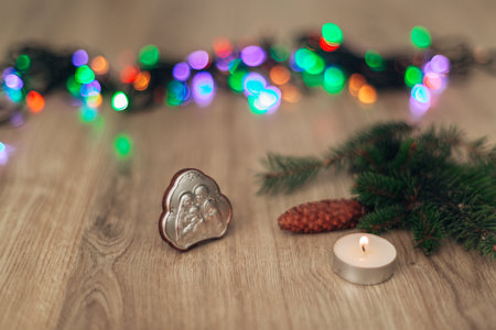 Christmas Composition of Church Icon on a Wooden Background With Multicolored Bokenの写真素材