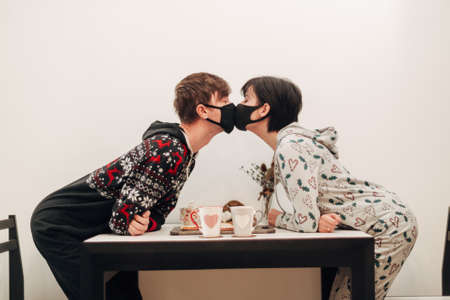 Girl and Guy Kissing in Masks on Quarantine COVID-19の写真素材