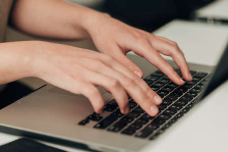 Close-Up Shot of Human Hands Placed Over Laptopの写真素材