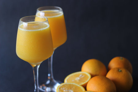 Glass of Kinnow Juice. It is juicier than orange and has more sour taste. The Kinnow is a high yield mandarin hybrid orange like fruit cultivated extensively in the wider Punjab region of India.の写真素材