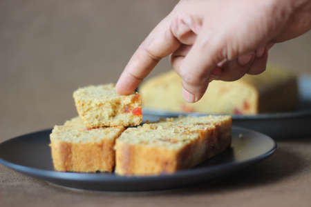 Slices of tutti frutti cake loaf made with whole wheat flour. Shot on white backgroundの写真素材
