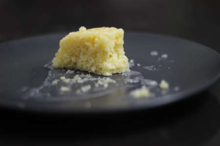Home baked Lemon blonde brownie slices with lemon glaze on top. Shot on white background
